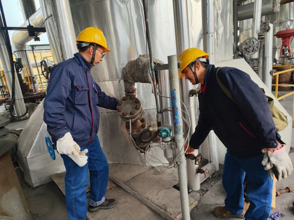 2月2日，計(jì)控電儀部李勝忠和胡含朗正在檢查氣化爐流量變送器的伴熱保溫情況.jpg